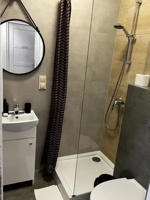 a bathroom with a shower and a sink at Apartamenty Nila in Kraków