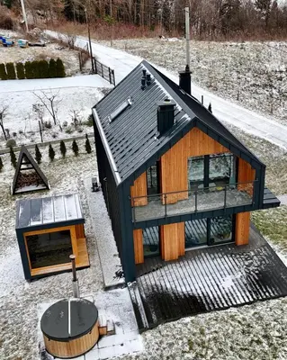an overhead view of a house with a black roof at Wood Lake Rożnów in Rożnów