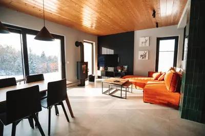 a living room with a couch and a table at Wood Lake Rożnów in Rożnów