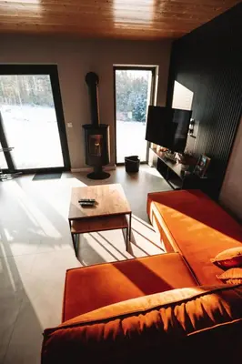 a bedroom with a bed and a tv and a table at Wood Lake Rożnów in Rożnów