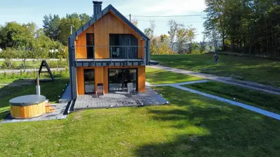a small house in the middle of a yard at Wood Lake Rożnów in Rożnów