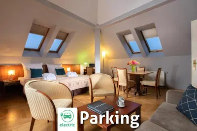 a room with a bed and a table and chairs at Red Brick Apartments in Kraków