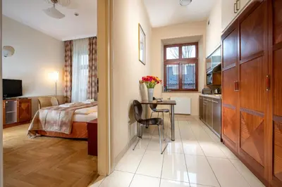 a bedroom with a bed and a table in a room at Red Brick Apartments in Kraków