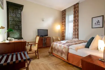 a hotel room with a bed and a tv at Red Brick Apartments in Kraków