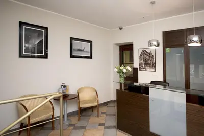 a dining room with a table and chairs at Red Brick Apartments in Kraków