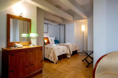 a hotel room with two beds and a mirror at Red Brick Apartments in Kraków