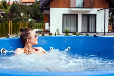 a young woman is in a swimming pool at Dolina Barw - całoroczne domki na wynajem in Rabka