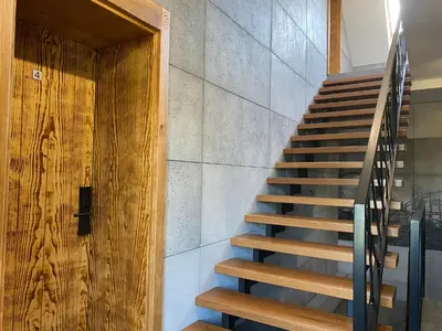 a staircase in a house with a wooden door at Apartamenty Zander in Zator