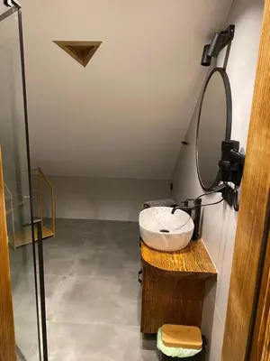 a bathroom with a sink and a mirror at Apartamenty Zander in Zator