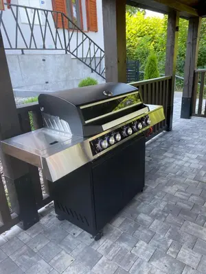 a barbecue grill on a patio with a table at Apartamenty Zander in Zator
