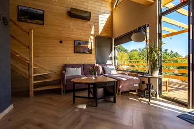 a living room with a couch and a table at Domki Jasicówka pod Łysą Górą in Limanowa