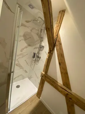a shower with a glass door in a bathroom at Lu Residence - Unique Apartments in Oświęcim