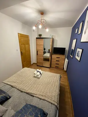 a bedroom with a bed and a mirror at Lu Residence - Unique Apartments in Oświęcim