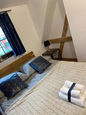 a bedroom with a bed with towels on it at Lu Residence - Unique Apartments in Oświęcim