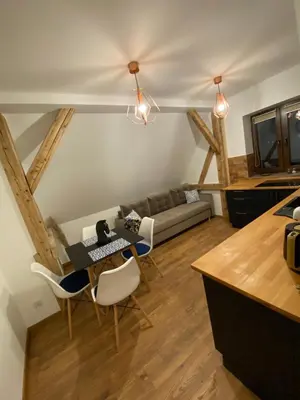 a living room with a table and chairs and a couch at Lu Residence - Unique Apartments in Oświęcim