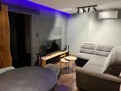 a living room with a couch and a tv at V&O Apartament Old Town Kazimierz in Kraków