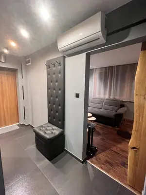 a living room with a couch and a air conditioner at V&O Apartament Old Town Kazimierz in Kraków