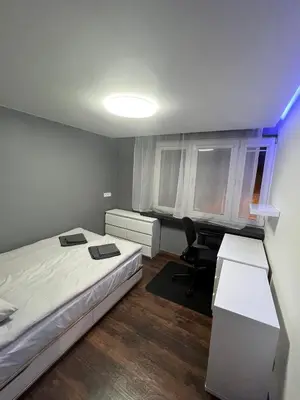 a small bedroom with a bed and a desk at V&O Apartament Old Town Kazimierz in Kraków