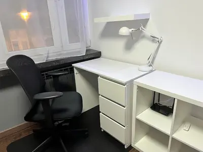 an office with a desk with a chair and a lamp at V&O Apartament Old Town Kazimierz in Kraków