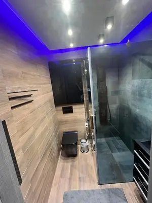a bathroom with a shower with a glass door at V&O Apartament Old Town Kazimierz in Kraków