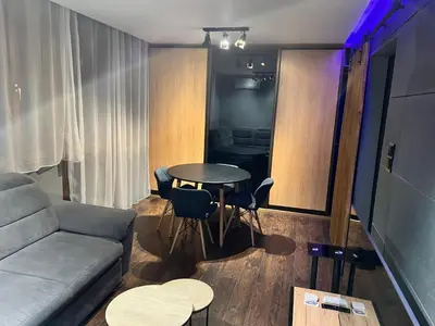 a living room with a couch and a table at V&O Apartament Old Town Kazimierz in Kraków