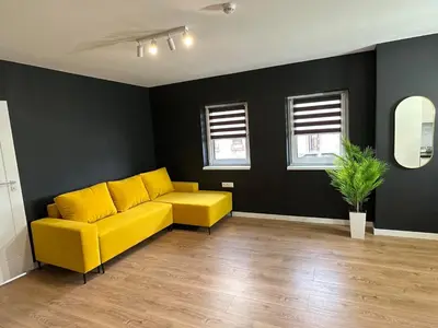 a dining room with a table and a mirror at Apartamenty Avia - Energylandia Zator in Spytkowice