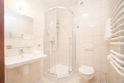 a bathroom with a shower and a toilet and a sink at H6 MAJOR ApartHotel Travel & Business, FREE PARKING in Kraków