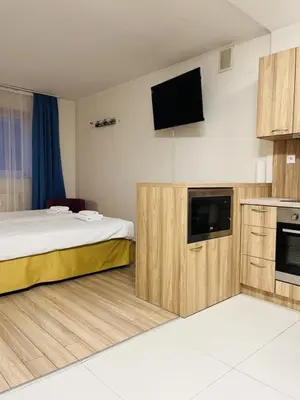 a hotel room with a bed and a flat screen tv at H6 MAJOR ApartHotel Travel & Business, FREE PARKING in Kraków
