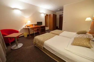 a hotel room with a bed and a desk at H6 MAJOR ApartHotel Travel & Business, FREE PARKING in Kraków