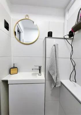 a white bathroom with a sink and a mirror at Krakowska Awangarda - Close to the Old Town in Kraków