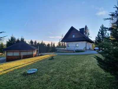 a large yard with two buildings and a house at Willa pod Babią Górą in Zubrzyca Górna