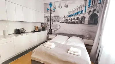 a bed with two white towels on top of it at Skawińska 10 by Homeprime in Kraków