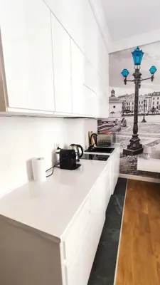 a kitchen with white cabinets and a counter top at Skawińska 10 by Homeprime in Kraków