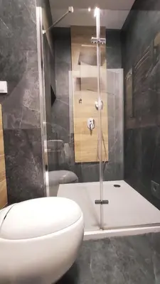 a bathroom with a white toilet and a shower at Skawińska 10 by Homeprime in Kraków
