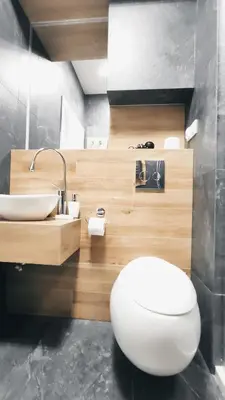 a bathroom with a white toilet and a sink at Skawińska 10 by Homeprime in Kraków
