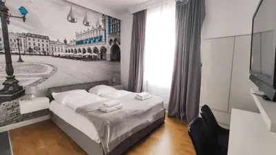 a bedroom with a bed with a picture of a city at Skawińska 10 by Homeprime in Kraków
