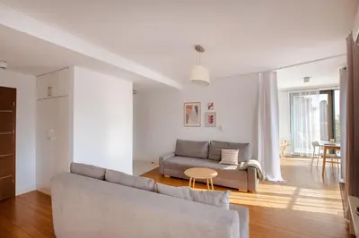 a living room with a couch and a table at Spacious apartment close to Main Station / Galeria Krakowska in Kraków