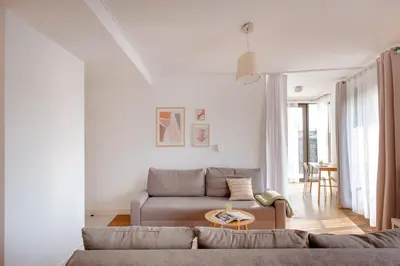 a living room with a couch and a table at Spacious apartment close to Main Station / Galeria Krakowska in Kraków
