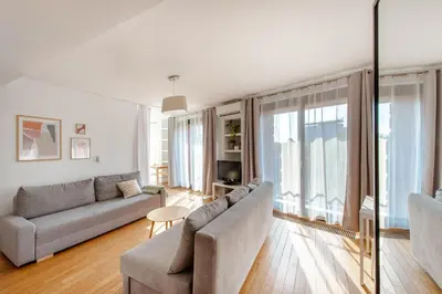 a living room with a couch and a table at Spacious apartment close to Main Station / Galeria Krakowska in Kraków