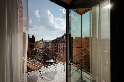 a balcony with chairs and a view of a city at Spacious apartment close to Main Station / Galeria Krakowska in Kraków