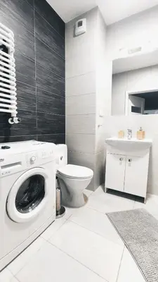 a bathroom with a washing machine and a toilet at Dąbska 18D by Homeprime in Kraków