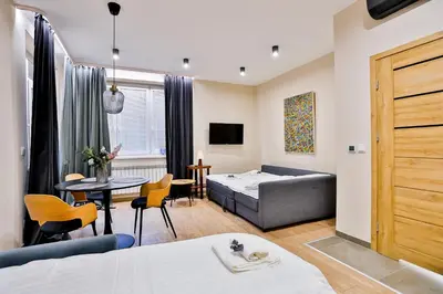 a living room with a bed and a table at Studio ArtDeco in Rabka