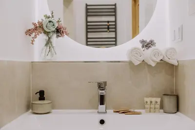 a bathroom sink with a faucet and a mirror at Studio ArtDeco in Rabka