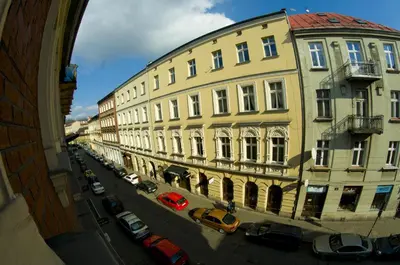 a view of a city street with buildings and cars at New Sweet One in Kraków