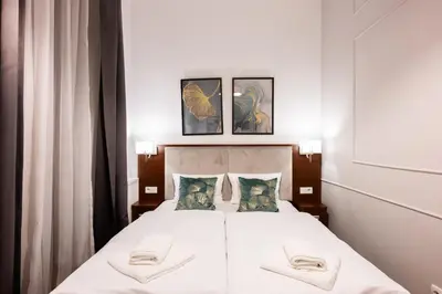 a bedroom with a bed with two towels on it at ON/SET APARTHOTEL in Kraków