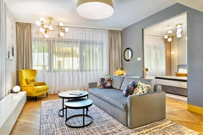 a lobby of a store with yellow chairs and tables at Hotel Ferreus Modern Art Deco in Kraków
