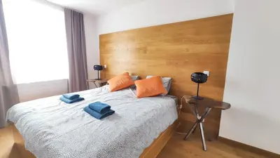a bedroom with a bed with two blue towels on it at Bogusławskiego 5 by Homeprime in Kraków