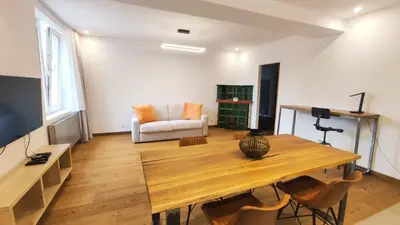 a living room with a wooden table and a couch at Bogusławskiego 5 by Homeprime in Kraków