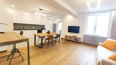 a kitchen and living room with a table and a couch at Bogusławskiego 5 by Homeprime in Kraków