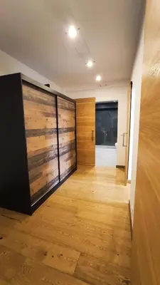 a hallway with wooden doors and a wooden floor at Bogusławskiego 5 by Homeprime in Kraków